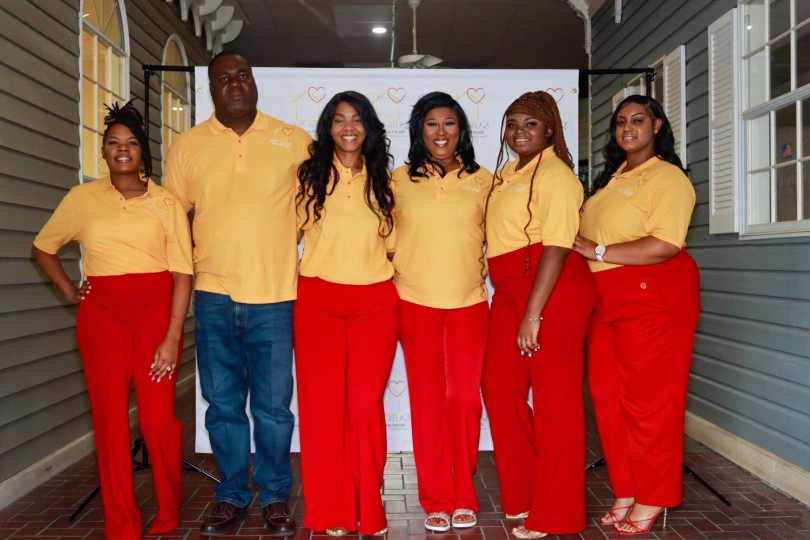 Hope House staff in yellow shirts and red pants
