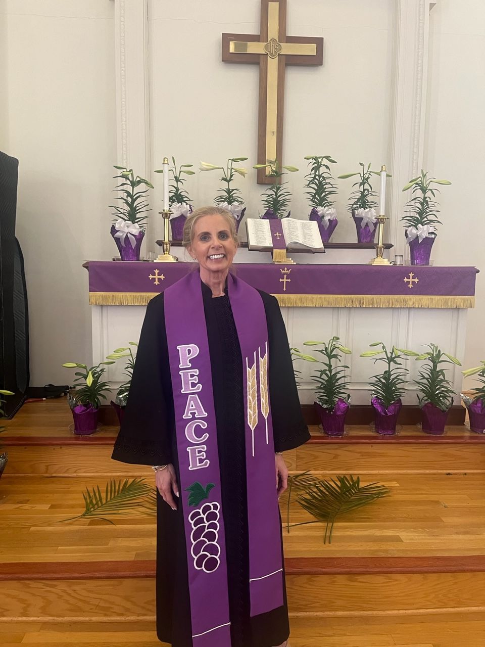 A woman wearing a purple scarf that says peace on it