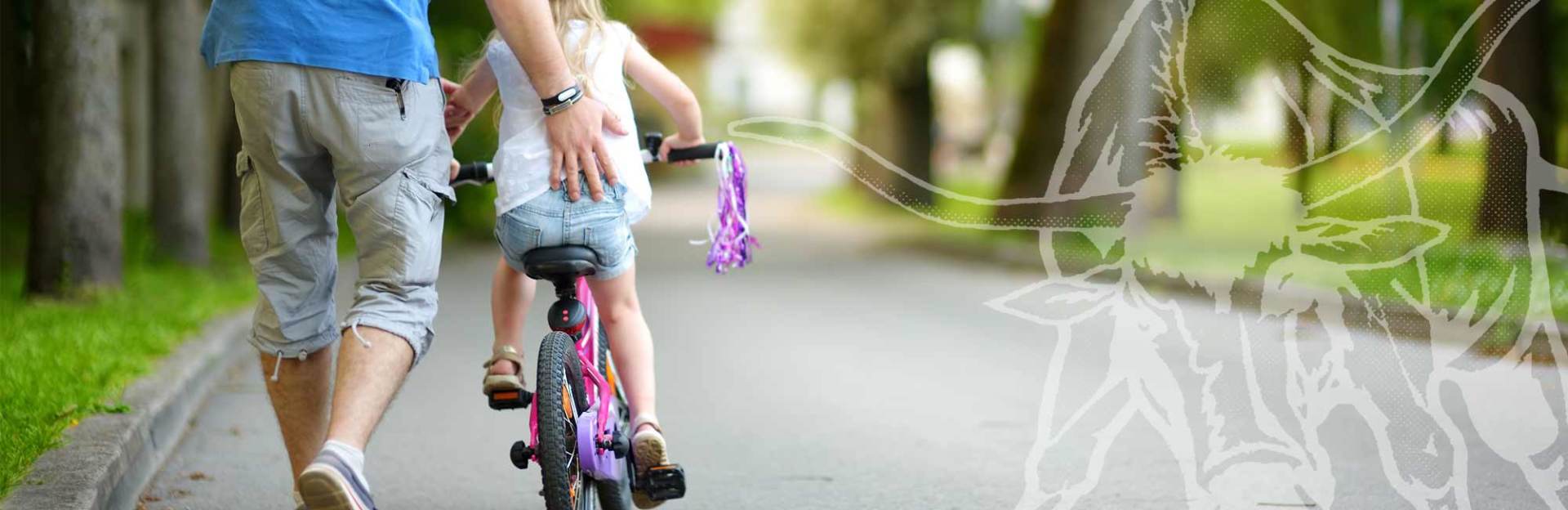 dad pushing daughter on bike