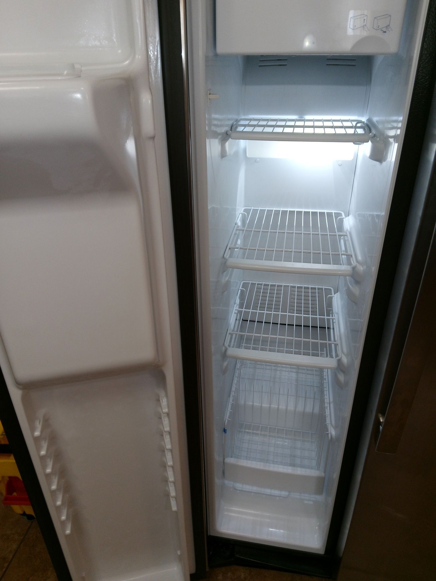The inside of an empty refrigerator with the door open.