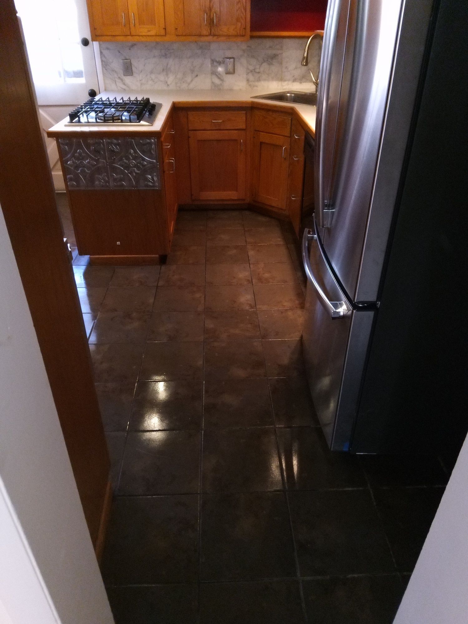 A kitchen with stainless steel appliances and wooden cabinets