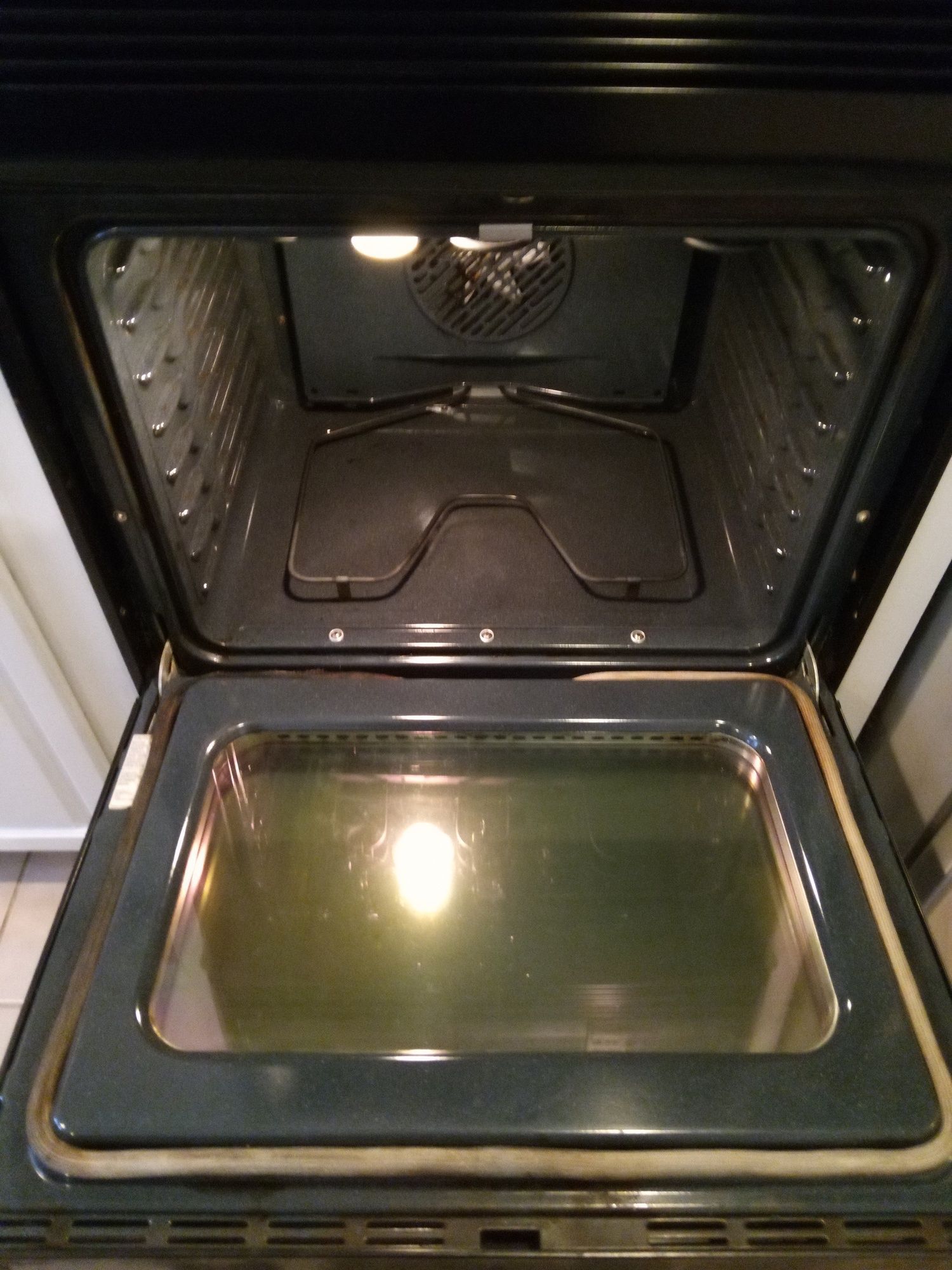 The inside of an oven is shown with the door open.