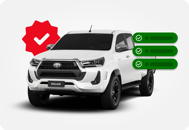 Caminhonete Toyota Hilux branca com marca de seleção vermelha e caixas de seleção verdes.