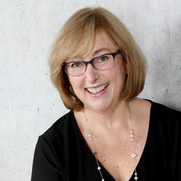 View Bio The woman is wearing a black shirt and smiling for the camera.