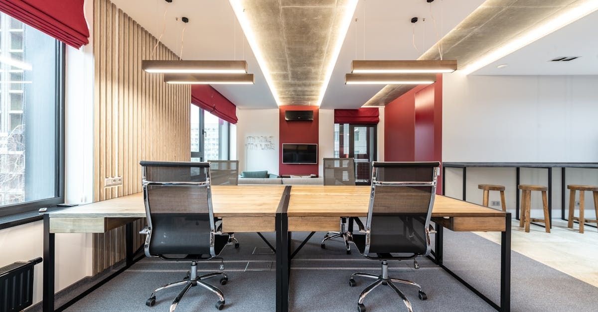 A modern office with a lot of desks and chairs.