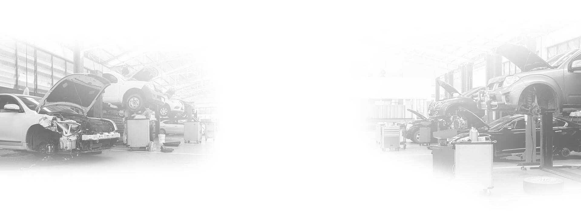 Cars being worked on inside of a repair shop. | Super Express Lube