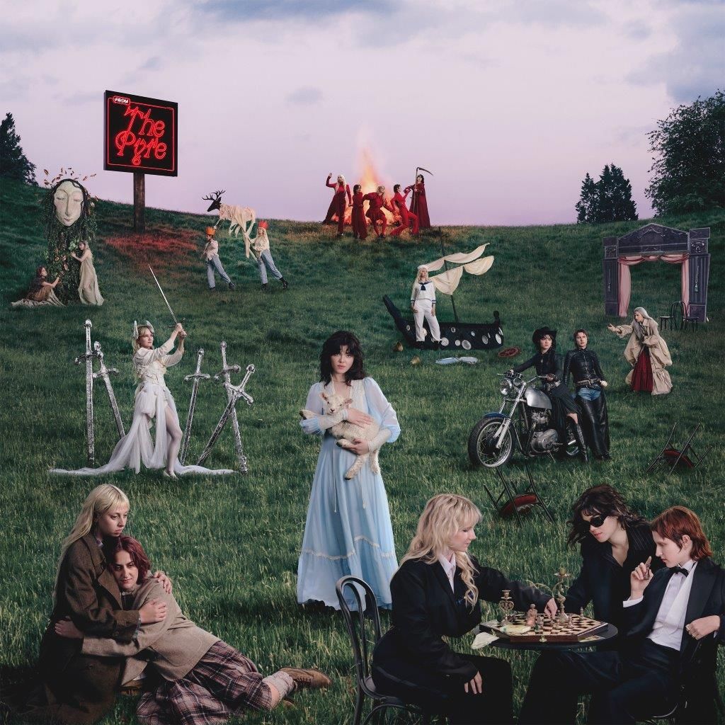 A knoll with people dressed up in fancy dress on it.
