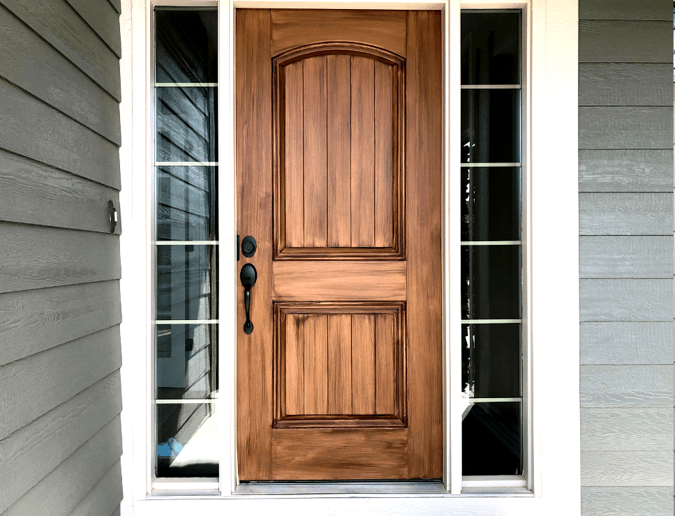 solid wood front door with glass panels on both sides and white trim