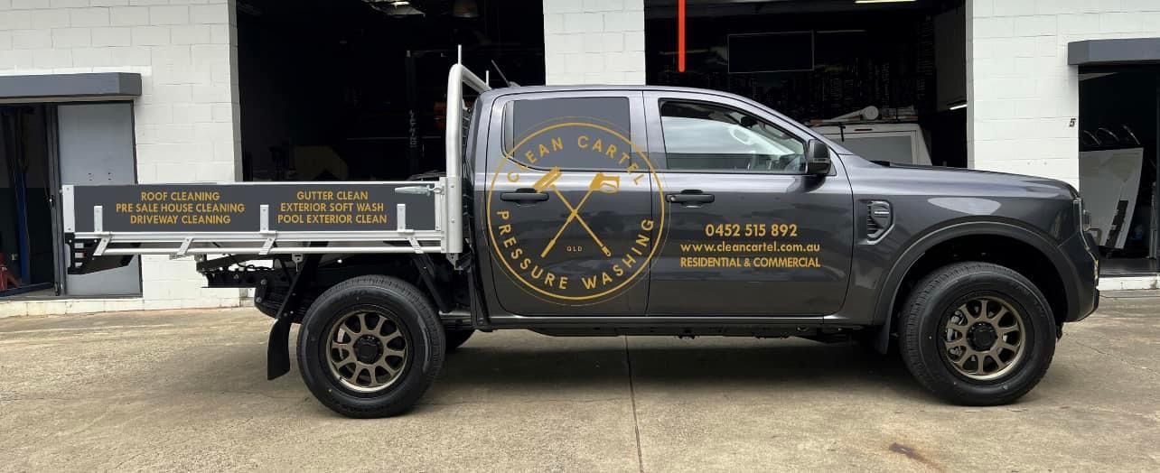 A Black Truck Is Parked In Front Of A Building — Clean Cartel Pressure Washing In Reedy Creek, QLD
