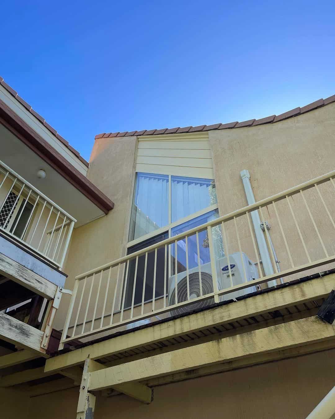 A Building With Stairs Leading Up To A Balcony With A Blue Sky In The Background — Clean Cartel Pressure Washing In Reedy Creek, QLD