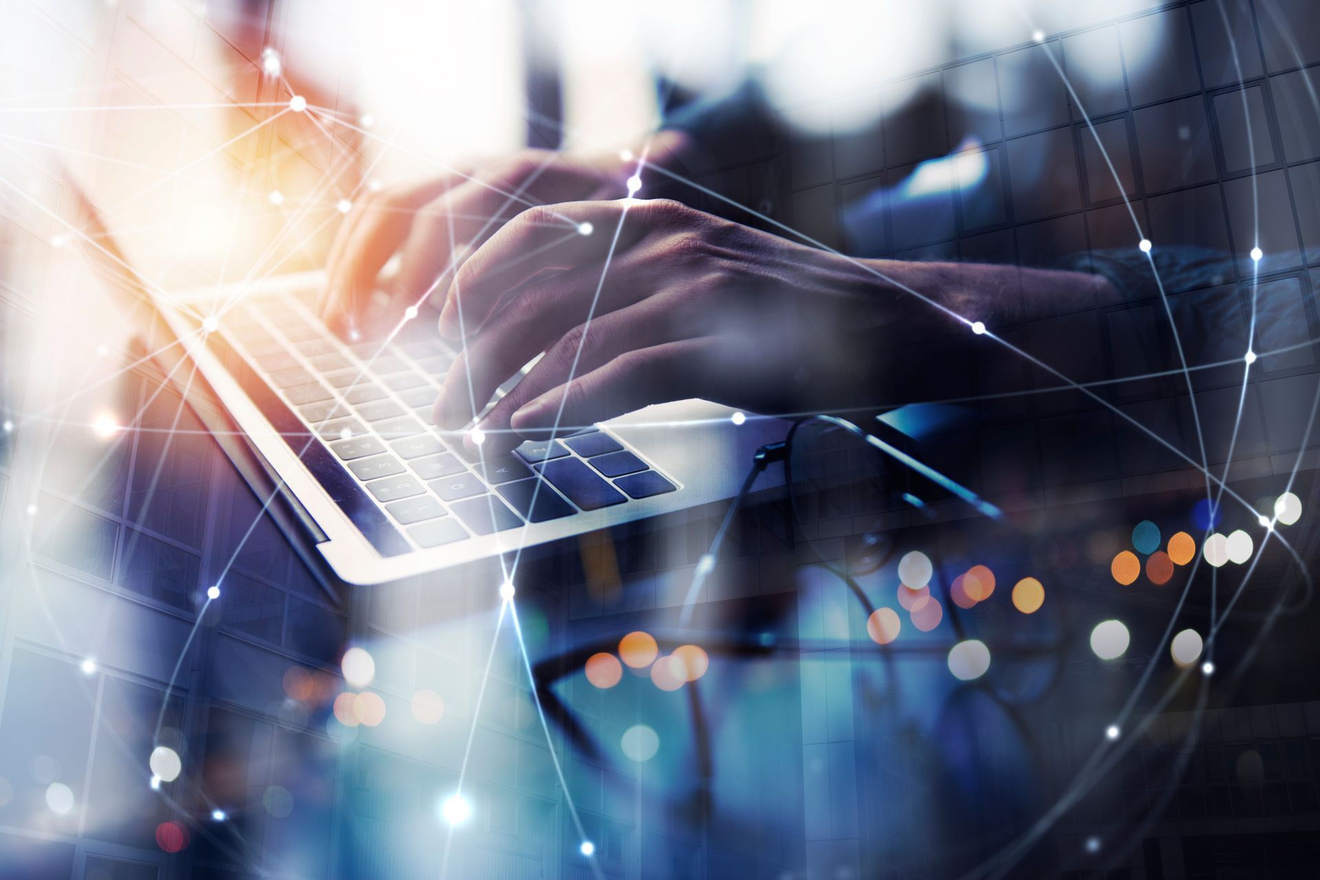 A person is typing on a laptop computer.