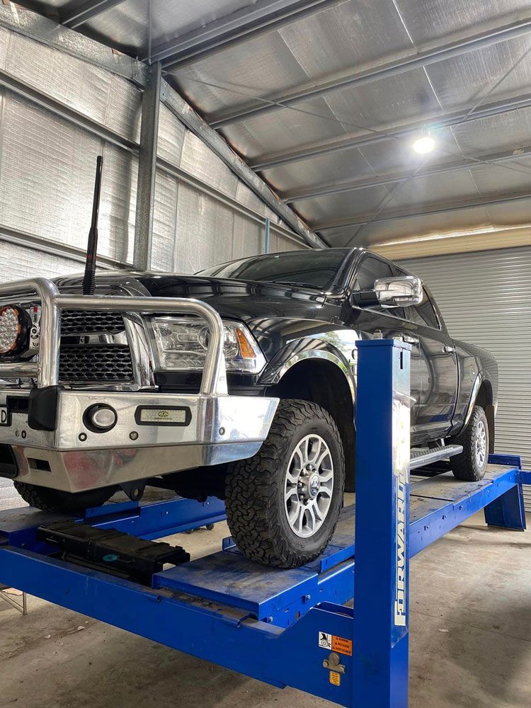 Black Pick Up On Car Lift — Towing Service In Walgett, NSW