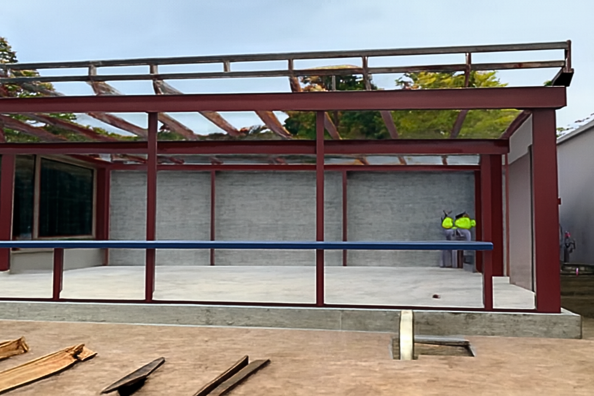 A construction worker is welding a metal structure on a scaffolding.