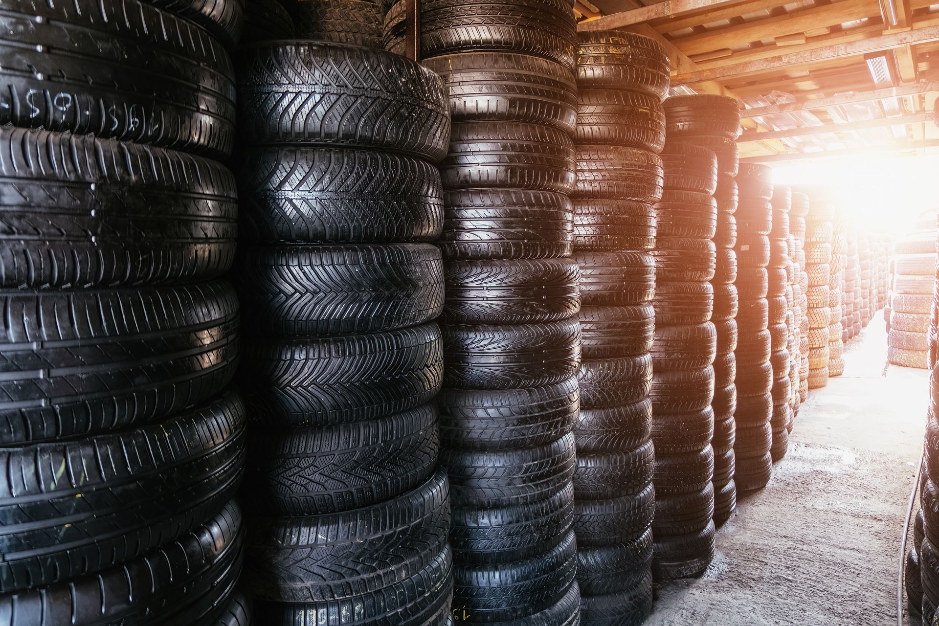 a warehouse filled with lots of tires stacked on top of each other .
