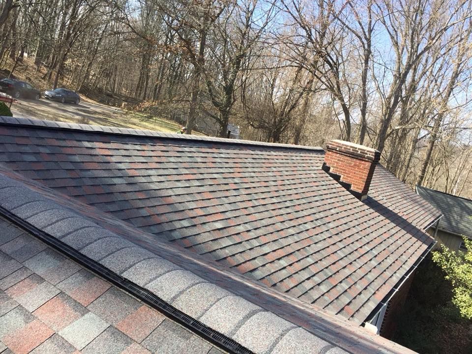 Close up of a roof ventilation system and ridge vent along a complete roof replacement by Four Seasons Roofing