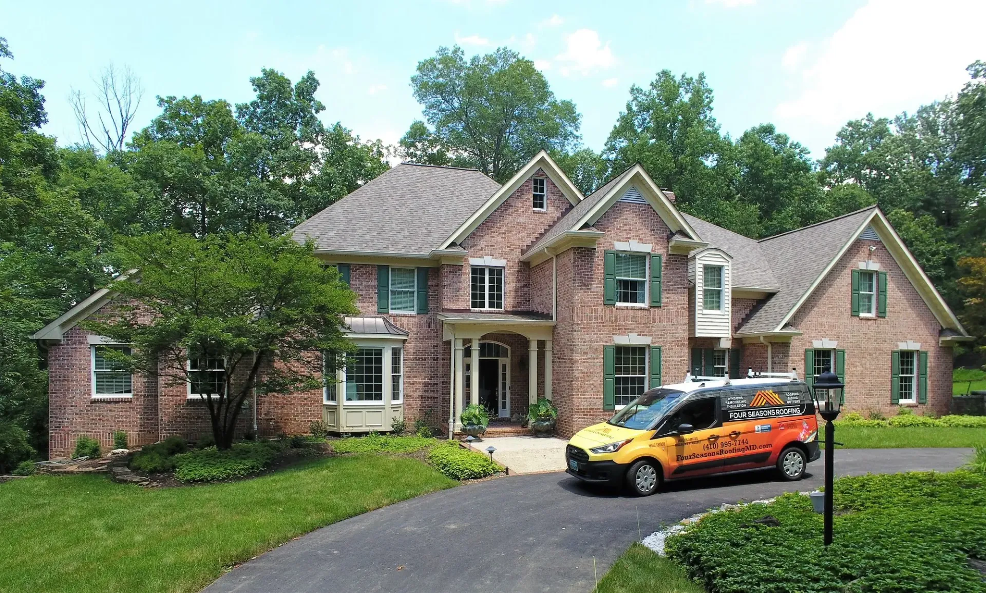 Residential home with new roof and gutter system installed by Four Seasons Roofing in Maryland.