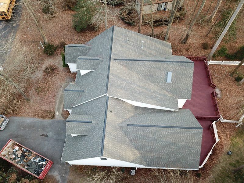 An aerial view of a house with a red roof