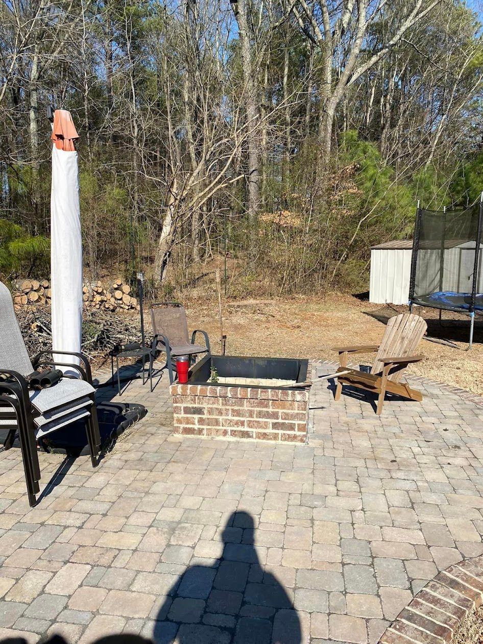 There is a fire pit in the middle of the patio.