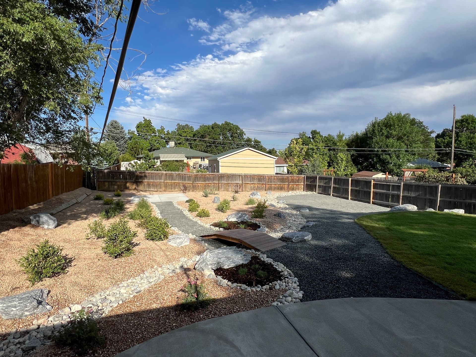 A foosball table is sitting in the dirt in front of a building.