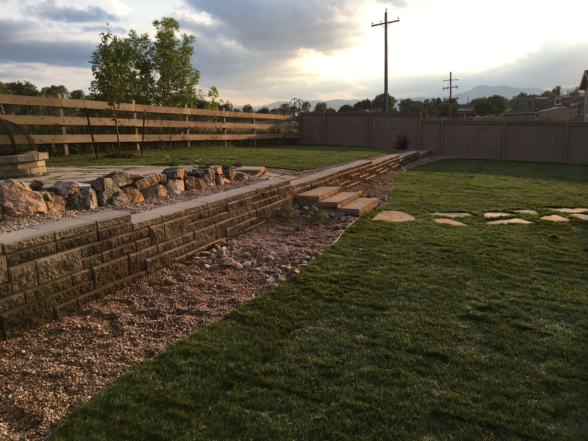 A wooden pergola is sitting in front of a house.