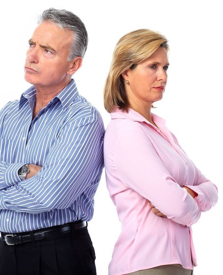 A Man And Woman Standing Back To Back With Their Arms Crossed — Charlestown Law Firm In Charlestown, NSW