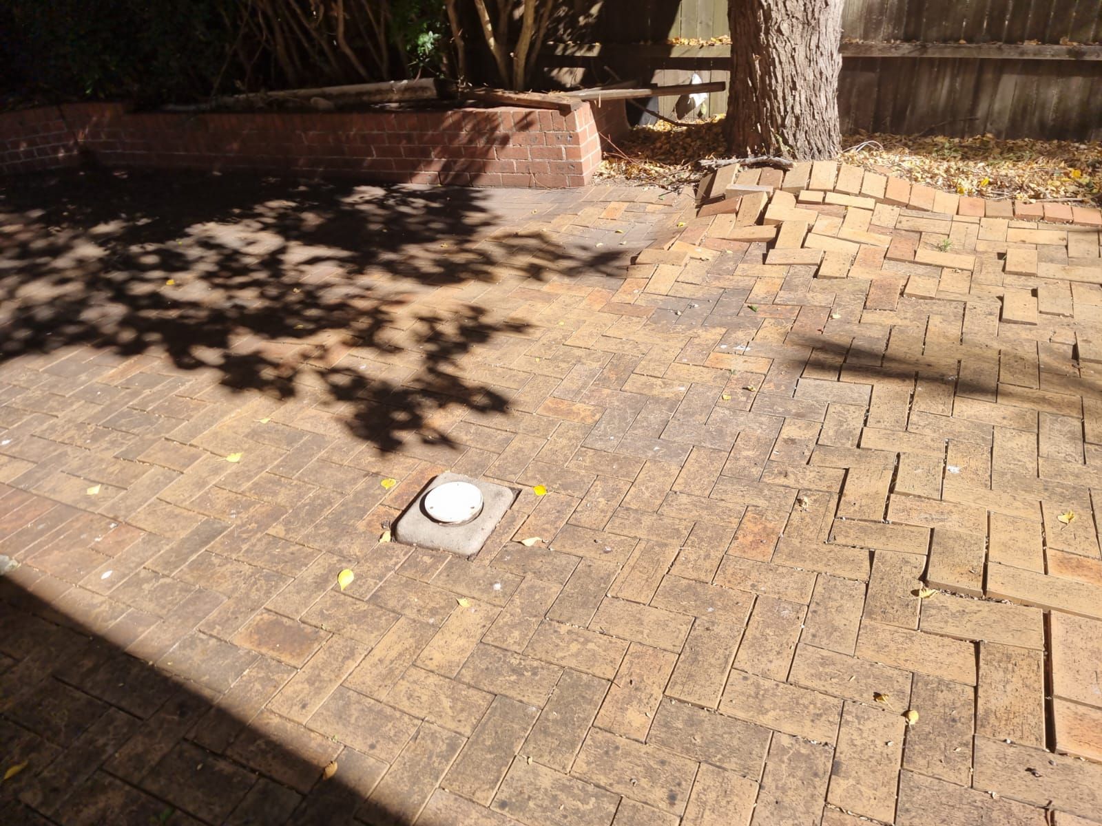 A brick patio with a light on top of it