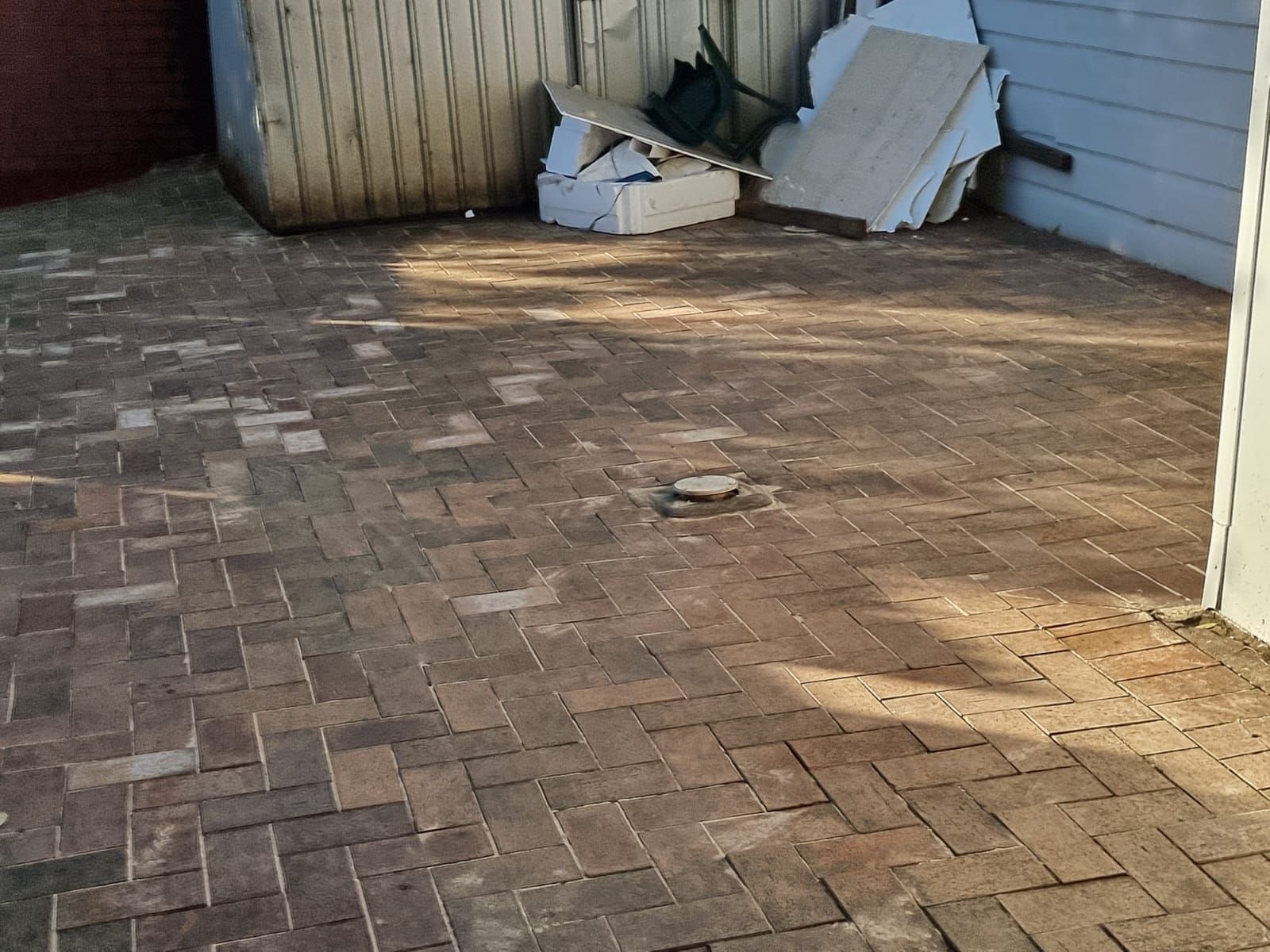 A brick floor with a few pieces of wood on it