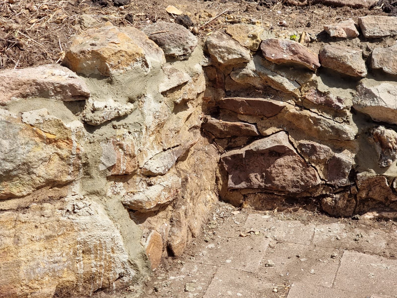 A close up of a stone wall with a hole in it.