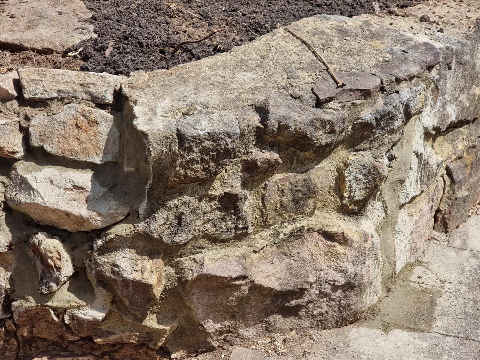 A close up of a stone wall with a lot of rocks.