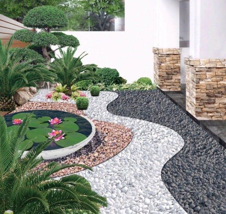 A garden with a pond with water lilies in it