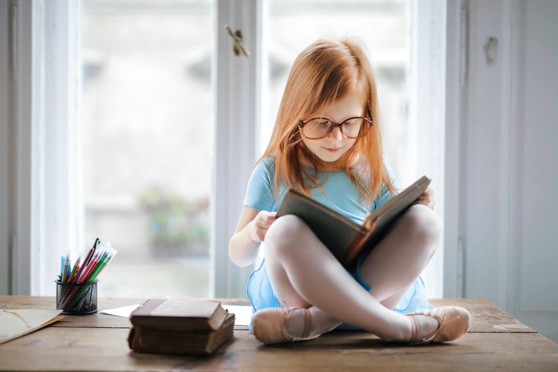 Girl with Glasses Reading Book Burlington optometry