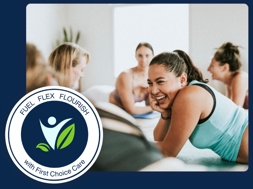 Women in a fitness class laugh. A blue and white logo says 