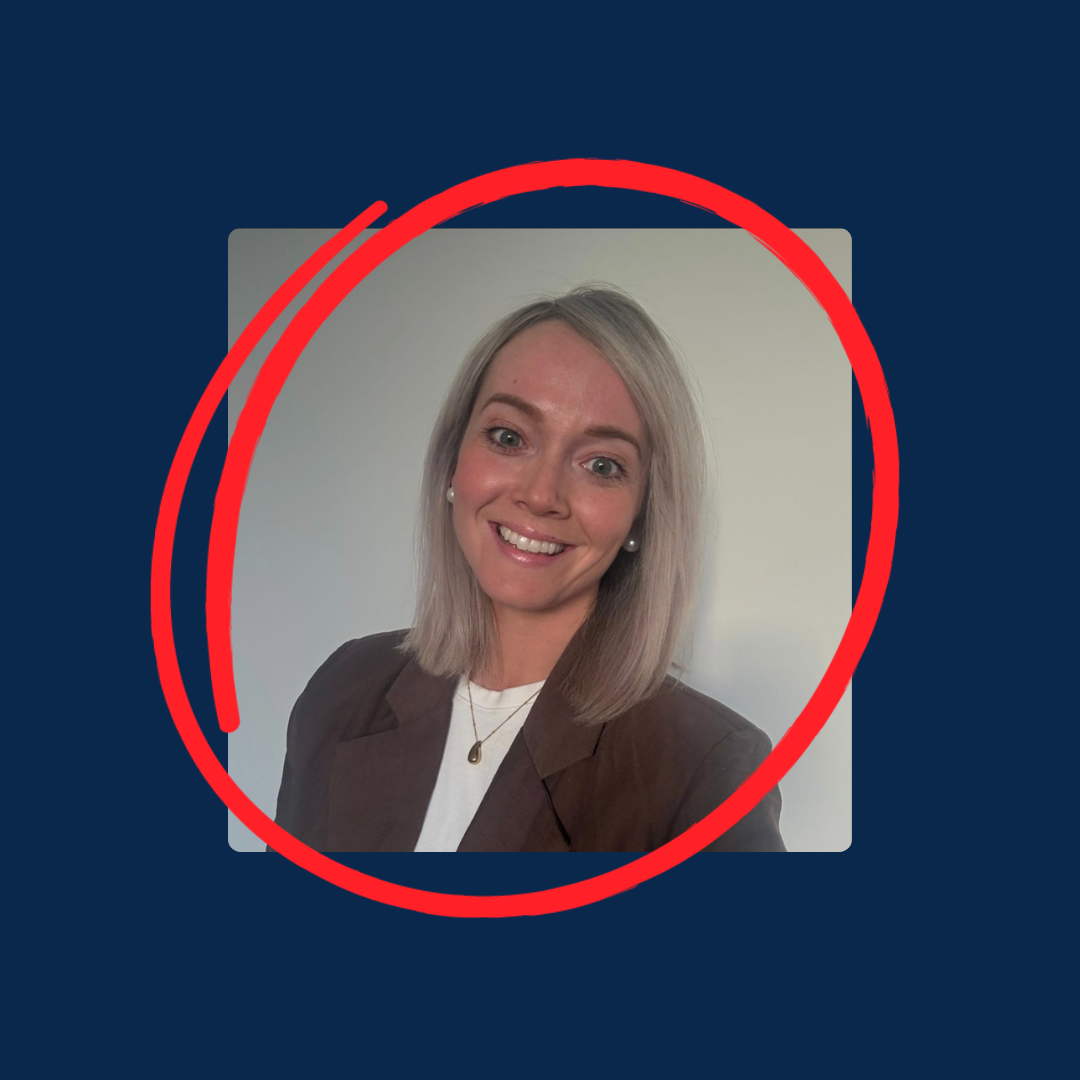 Smiling woman in a brown blazer, circled in red against a light blue background