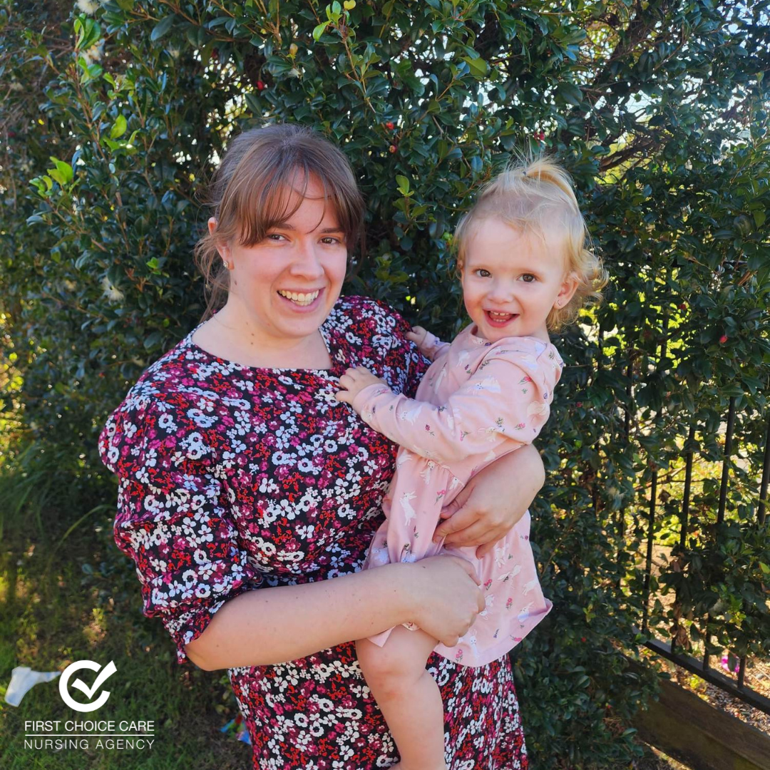 A woman is holding a little girl in her arms.