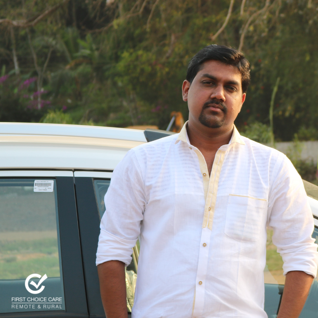 A man in a white shirt stands in front of a car that says best choice care