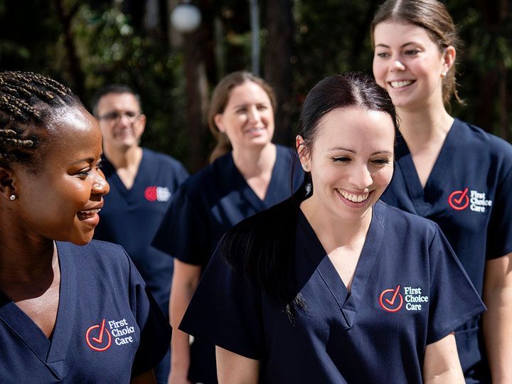 Two nurses are walking down a hospital hallway.