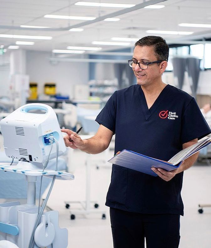 A surgeon is talking to another surgeon in a hospital room.