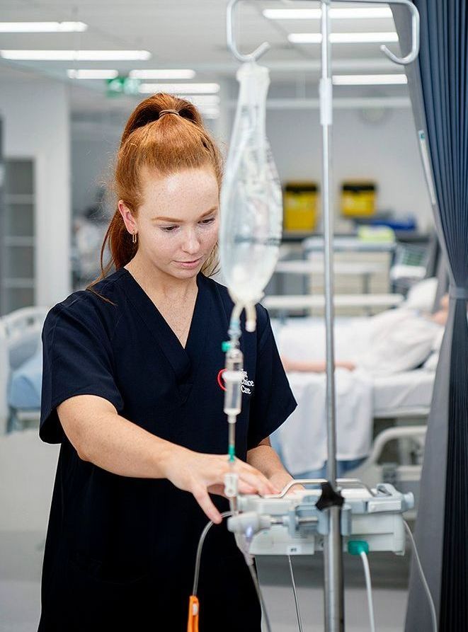 A surgeon is talking to another surgeon in a hospital room.