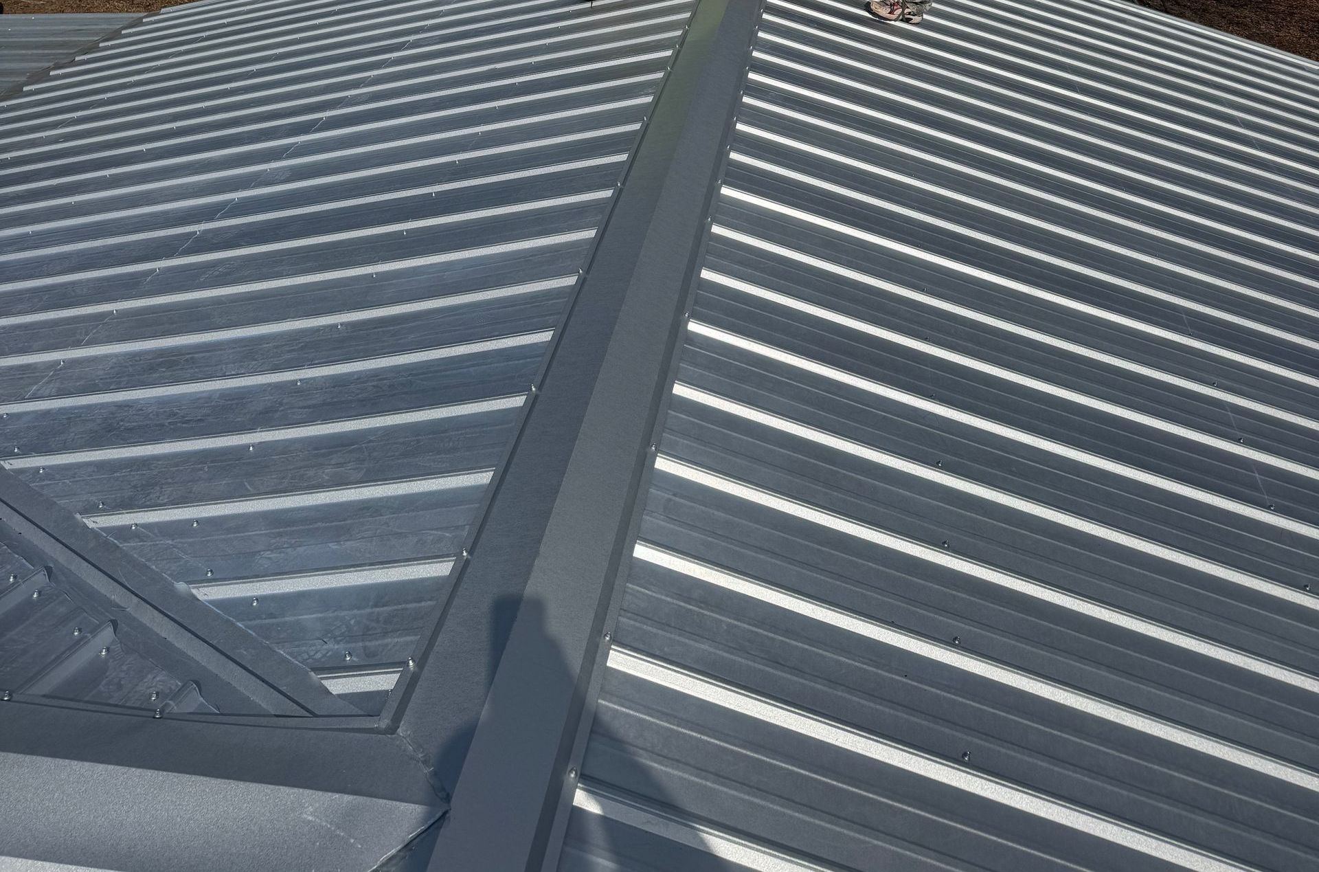 A close up of a metal roof with white stripes