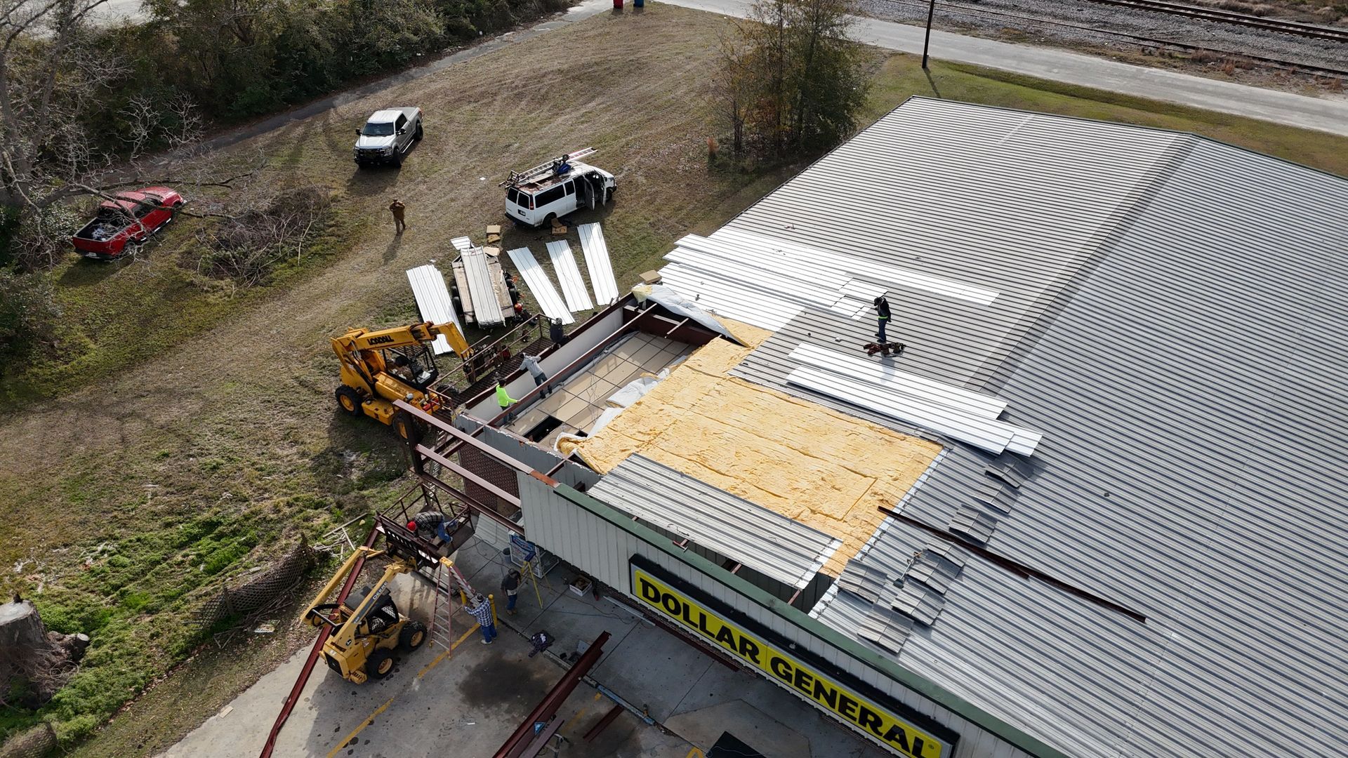 An aerial view of a building under construction with a crane on the roof.
