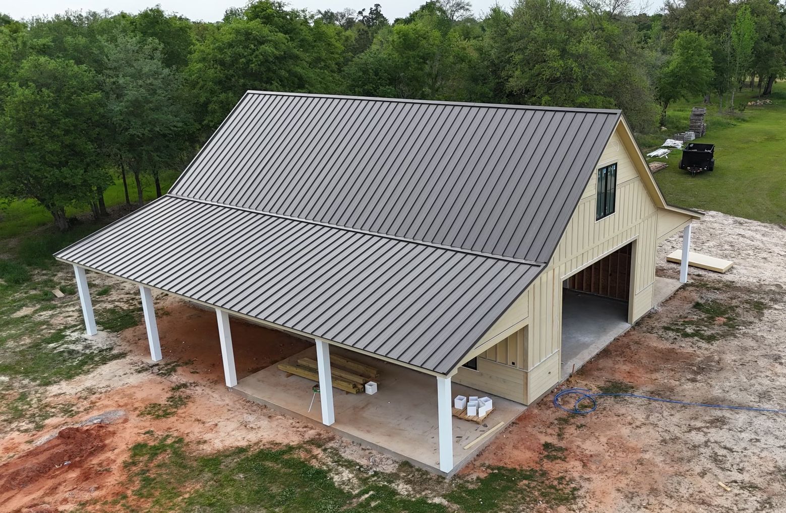 An aerial view of a building under construction with a metal roof.