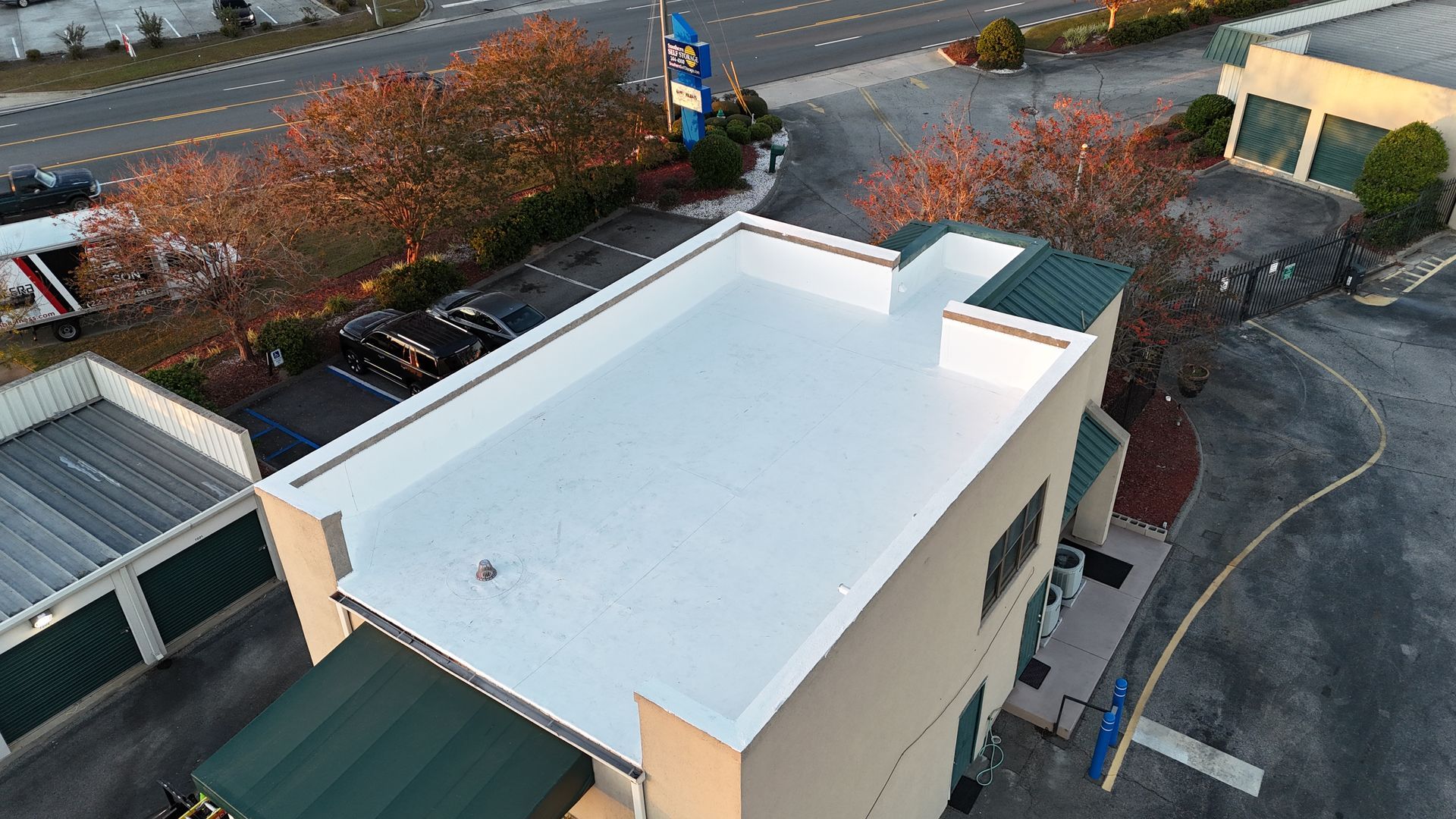 An aerial view of a building with a white roof.