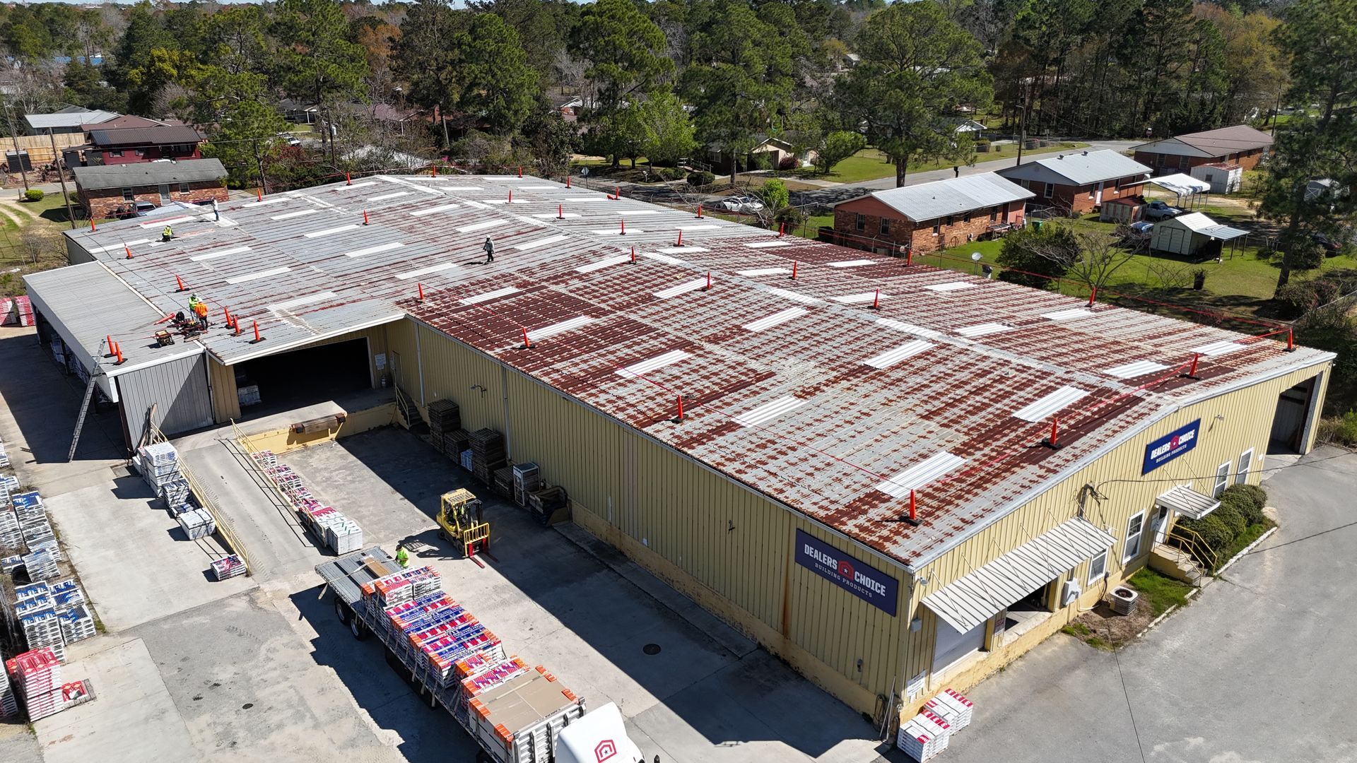 An aerial view of a large building with a rusty roof.