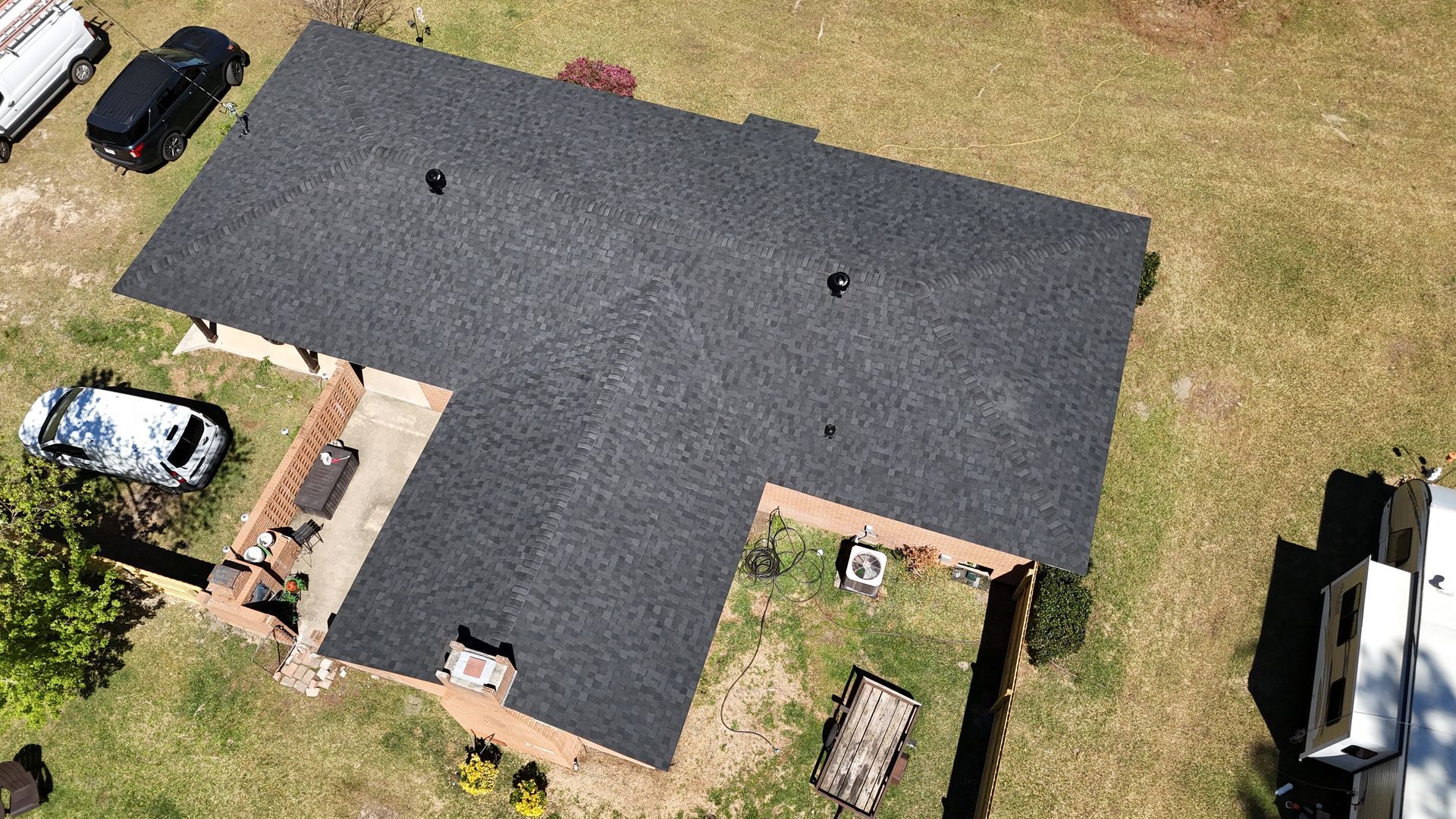 An aerial view of a house with a new roof.
