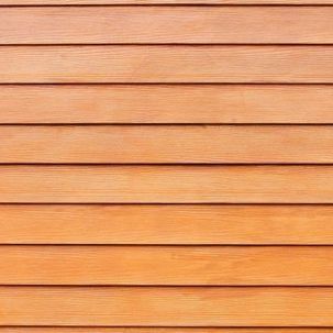 A close up of a wooden siding on a house.