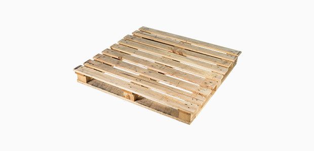 A wooden pallet is sitting on a white surface.