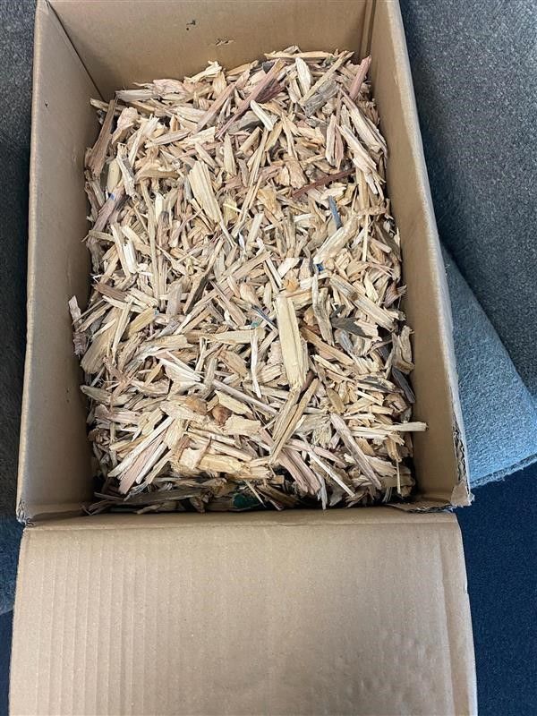A pile of wood shavings on a white background.