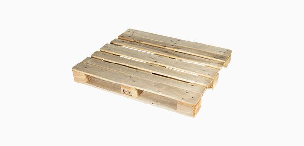 A wooden pallet is sitting on a white surface.