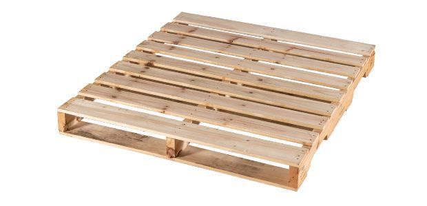 A wooden pallet is sitting on a white surface.