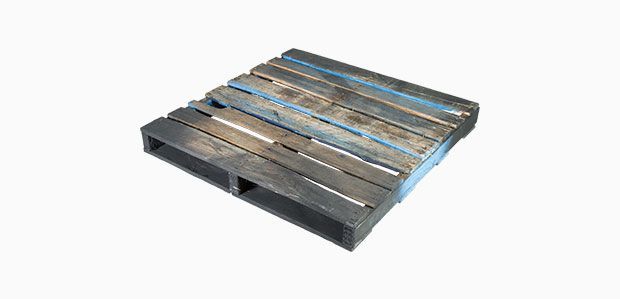 A wooden pallet is sitting on a white surface.
